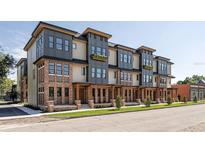 Beautiful modern townhomes feature brick facade and covered entryways at 409 E Oak Ave # 9, Tampa, FL 33602