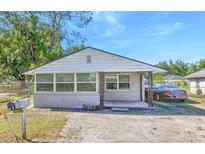 Charming single-story home featuring a cozy front porch and a well-maintained front yard at 905 W Ball St, Plant City, FL 33563