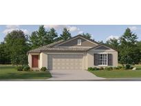 Charming single-story home with a well-manicured lawn, featuring a two-car garage and traditional architectural details at 10258 Gentle Rain Dr, Land O Lakes, FL 34638