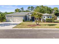 Charming single-story home featuring a 2-car garage and well-manicured lawn at 10726 Miracle Ln, New Port Richey, FL 34654