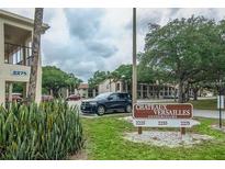 Chateaux Versailles Condominiums, featuring a lush green space and well-maintained buildings in a desirable community at 2275 62Nd N Ave # 5202, St Petersburg, FL 33702