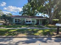 Charming single-story home featuring a well-manicured lawn and mature trees adding great curb appeal at 2830 W Bay Haven Dr, Tampa, FL 33611