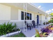 Inviting front porch with charming seating and well-maintained landscaping at 3599 66Th N Way, St Petersburg, FL 33710