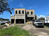 New construction home featuring block construction and a two-car garage in a residential neighborhood at 4321 S Renellie Dr, Tampa, FL 33611