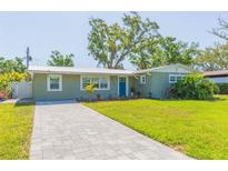 Charming single-story home with a well-manicured lawn and inviting blue front door at 4516 S Trask St, Tampa, FL 33611