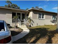 Single-story home featuring a combination of painted siding and brick accents with lush landscaping in the front yard at 5151 22Nd N Ave, St Petersburg, FL 33710