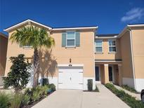 Inviting two-story home with a one car garage, a palm tree, and attractive landscaping at 5509 Cumberland Star Ct, Lutz, FL 33558
