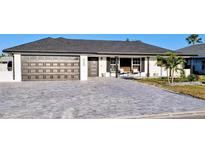 Charming home featuring a well-maintained brick driveway, attached garage, and manicured landscaping at 6337 Cocoa Ln, Apollo Beach, FL 33572