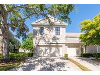 Charming two-story townhome with a well-maintained lawn and a two-car garage at 7826 66Th N Way, Pinellas Park, FL 33781