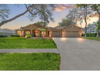 Charming single-story home with a three-car garage and well-manicured lawn at 8933 Crescent Forest Blvd, New Port Richey, FL 34654