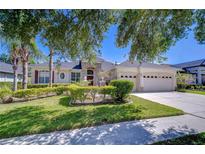 Lovely single-story home with a stone accent entryway, attached 3-car garage, and well-manicured front lawn at 9211 Everwood Ct, Tampa, FL 33647