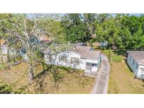 An aerial view of a charming single-story home featuring a well-maintained yard and mature trees at 1025 W Berry Ave, Tampa, FL 33603
