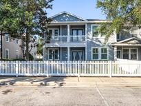 Charming two-story home features a welcoming balcony and a classic white picket fence at 16127 Churchview S Dr, Lithia, FL 33547