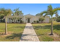 Charming single-story home with lush lawn, landscaped yard, and inviting pathway at 5298 Oxford N Ave, St Petersburg, FL 33710