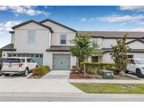 Charming townhome showcasing a well-manicured lawn and a two-car garage, nestled in a desirable neighborhood at 5429 Companion Ln, Tampa, FL 33619