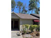 Inviting exterior of a home featuring lush landscaping and visible street number at 8405 Laurelon Pl, Temple Terrace, FL 33637