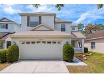 Charming two-story home featuring a two-car garage, manicured lawn and front garden at 20123 Bay Cedar Ave, Tampa, FL 33647