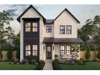 Charming two-story home featuring a stone facade, black framed windows and professionally landscaped front yard at 211 29Th Ave N, St Petersburg, FL 33704