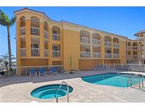 Stunning condo building featuring a pool, hot tub, and marina access at 5353 Gulf Blvd # B103, St Pete Beach, FL 33706
