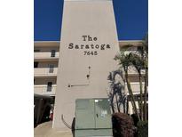 The Saratoga condominium building featuring a clean exterior design with lush, green landscaping at 7645 Sun Island S Dr # 306, South Pasadena, FL 33707