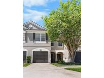 Charming home with gray exterior, dark shutters and a well manicured lawn at 10212 Westpark Preserve Blvd, Tampa, FL 33625