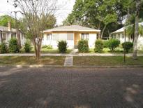 Charming single-story home with a brick road, mature landscaping, and a cozy front porch at 1035 15Th S Ave, St Petersburg, FL 33705