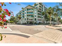 Contemporary building exterior with balconies, mature trees and a corner view on a sunny day at 111 N 12Th St # 1502, Tampa, FL 33602