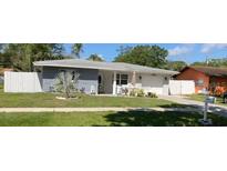 Well-maintained single-story home featuring a manicured lawn and charming curb appeal at 1748 Ragland Ave, Clearwater, FL 33765