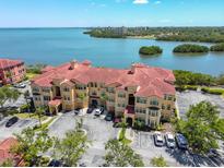 Mediterranean-style condos feature red tile roofs, lush landscaping, and convenient parking near the bay at 2739 Via Capri # 1024, Clearwater, FL 33764