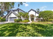 Charming two-story home featuring a well-manicured lawn and elegant landscaping at 3329 Cypress Landing Dr, Valrico, FL 33596