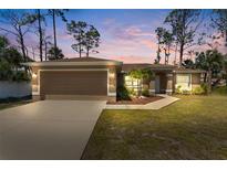 Charming single-story home featuring a two-car garage, well-maintained landscaping, and a cozy front entrance at 4344 Eldron Ave, North Port, FL 34286