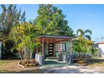 Charming home featuring well-maintained landscaping, colorful foliage and an inviting front porch at 4730 15Th N Ave, St Petersburg, FL 33713
