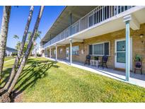Inviting condo exterior featuring a well-kept lawn and neutral color scheme at 5247 81St N St # 4, St Petersburg, FL 33709