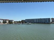 Scenic waterfront view of the condo complex, featuring a marina, beautiful buildings and calm water at 5940 30Th S Ave # 206, Gulfport, FL 33707