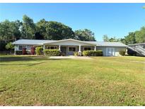 Charming single-story home with a well-manicured lawn and beautiful landscaping at 1203 Durant Rd, Brandon, FL 33511