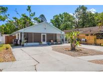 Charming single story home featuring a screened porch, landscaped front yard and spacious driveway at 3105 Gordon Ct, Tampa, FL 33619