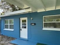Charming blue home featuring a covered porch and freshly painted brick exterior at 4316 70Th N Ave, Pinellas Park, FL 33781