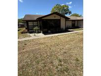 Charming single story home featuring neutral paint, decorative rock, and a walkway to the front door at 4556 Blossom Blvd # B, Zephyrhills, FL 33542