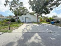 Charming single-story home with a concrete driveway and well-maintained front yard landscaping at 112 N Betty Ln, Clearwater, FL 33755