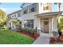 Inviting townhouse facade with well-maintained lawn and manicured landscaping at 13777 Forest Lake Dr, Largo, FL 33771
