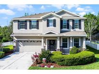 Charming two-story home features a well-maintained yard, neutral paint, and a two car garage at 27549 Stonecreek Way, Wesley Chapel, FL 33544