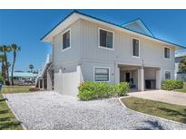 Coastal home featuring gravel landscaping, covered parking, and a light-blue metal roof at 4275 Bellaire Dr, Hernando Beach, FL 34607