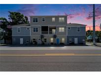 Charming two-story exterior featuring a mix of brick and neutral siding, complemented by inviting blue door at 718 S 22Nd St, Tampa, FL 33605
