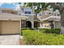 Charming townhome exterior with well-manicured landscaping and inviting curb appeal at 8125 Stone Path Way, Tampa, FL 33647