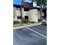 Building exterior featuring clean landscaping and a dedicated parking space for residents and guests at 825 S Village N Dr # 201, St Petersburg, FL 33716