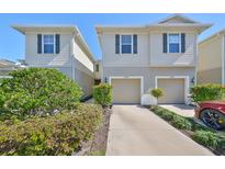 Well-maintained townhome with a two-car garage and beautifully landscaped front yard at 10947 Verawood Dr, Riverview, FL 33579