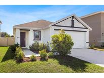 Well-manicured lawn and landscaping highlight this charming single-Gathering home at 12168 Lily Magnolia Ln, Riverview, FL 33569