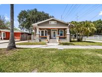 Charming single-story home with a welcoming front porch and well-manicured lawn at 2224 Gordon St, Tampa, FL 33605