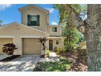 Charming two-story townhome featuring attached garage and lovely landscaping at 2915 Royal Tuscan Ln, Valrico, FL 33594