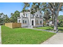 Stunning two-story home boasting a lush green lawn, new wood fence, and mature trees at 3000 19Th S Ave, St Petersburg, FL 33712